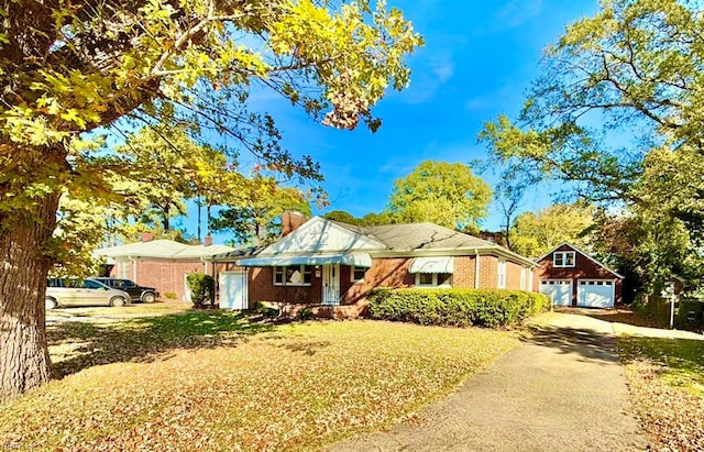 view of front facade with an outbuilding and a garage