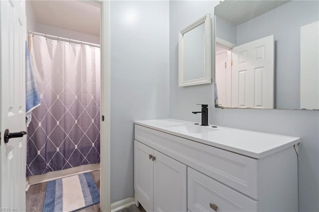 bathroom featuring a shower with curtain and vanity