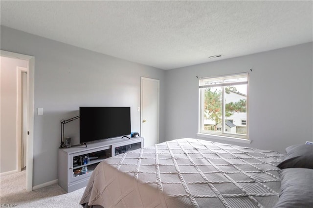 bedroom featuring carpet and a textured ceiling