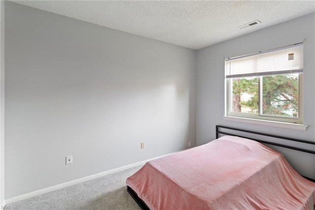 carpeted bedroom with a textured ceiling