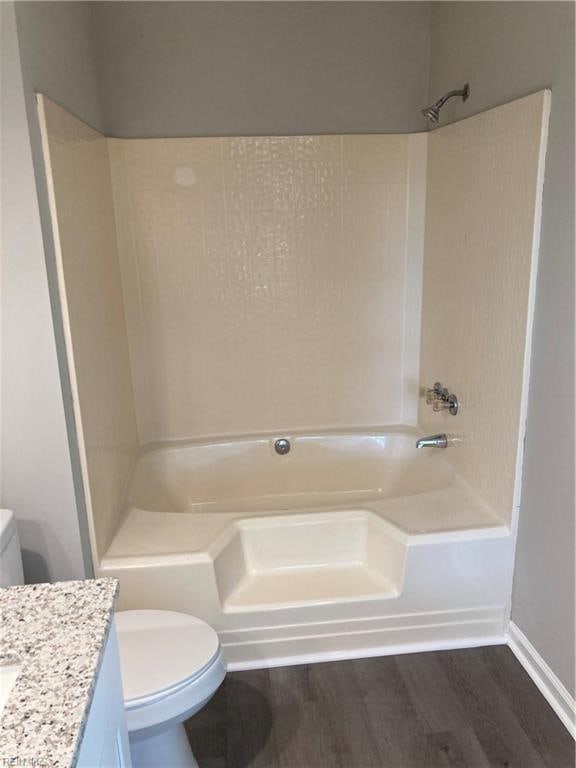 full bathroom featuring toilet, shower / washtub combination, vanity, and hardwood / wood-style flooring