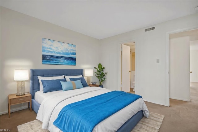 carpeted bedroom featuring ensuite bathroom