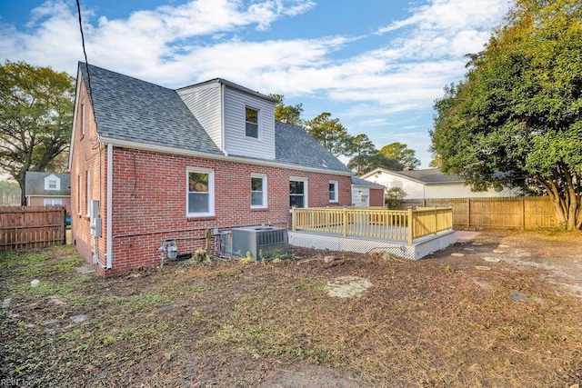 back of property with cooling unit and a deck