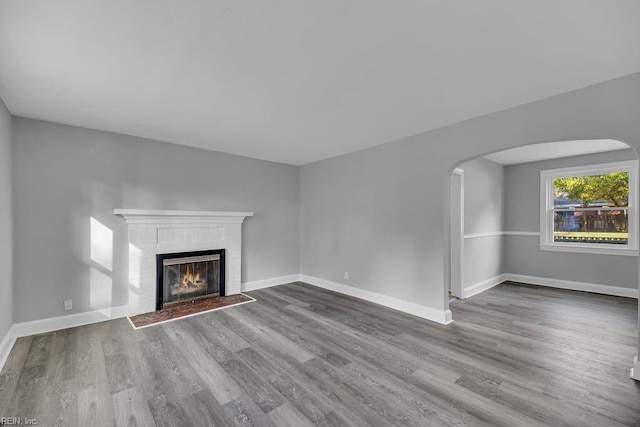 unfurnished living room with a fireplace and hardwood / wood-style floors