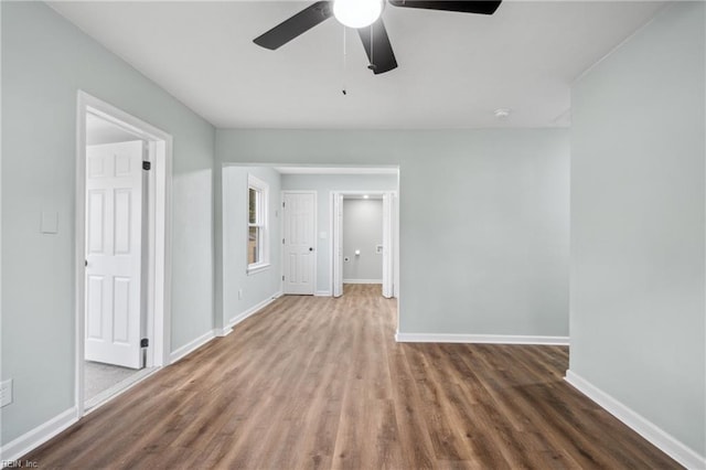 empty room with ceiling fan and hardwood / wood-style floors