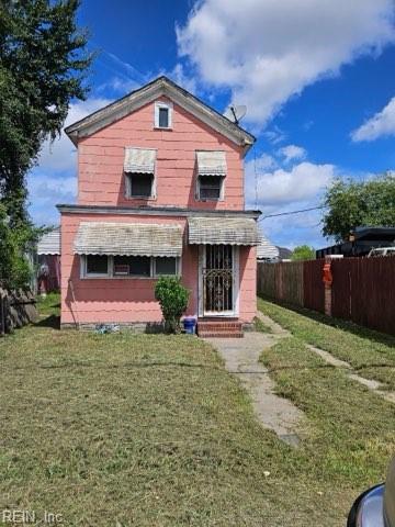 back of property featuring a yard