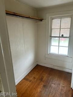 unfurnished room with dark hardwood / wood-style flooring