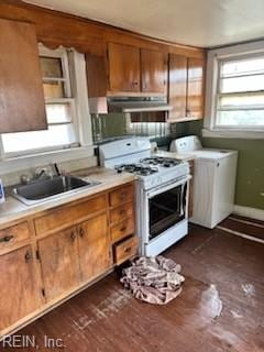 kitchen featuring washer / clothes dryer, white gas stove, dark wood-type flooring, and sink