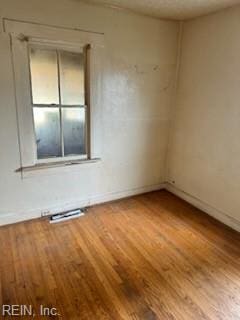 empty room with hardwood / wood-style flooring