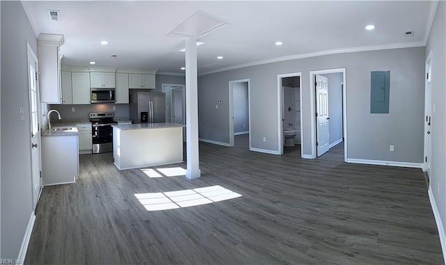 kitchen with white cabinetry, dark wood-type flooring, a kitchen island, and stainless steel appliances