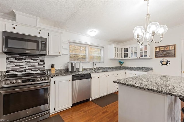 kitchen featuring appliances with stainless steel finishes, white cabinetry, and sink