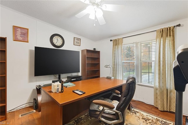 office featuring ceiling fan, hardwood / wood-style floors, crown molding, and a textured ceiling