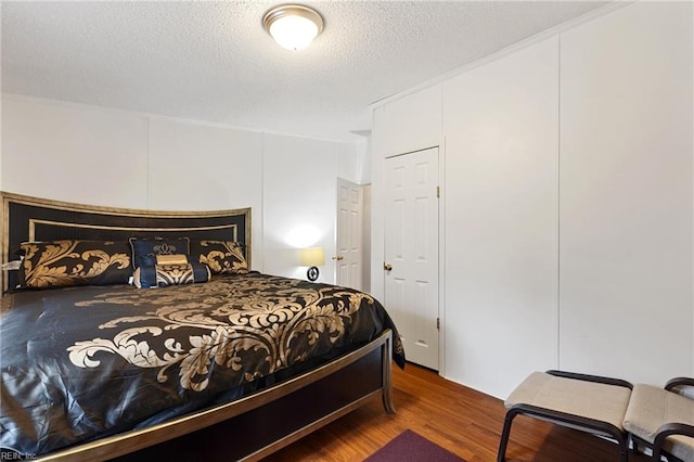 bedroom featuring a textured ceiling and hardwood / wood-style flooring