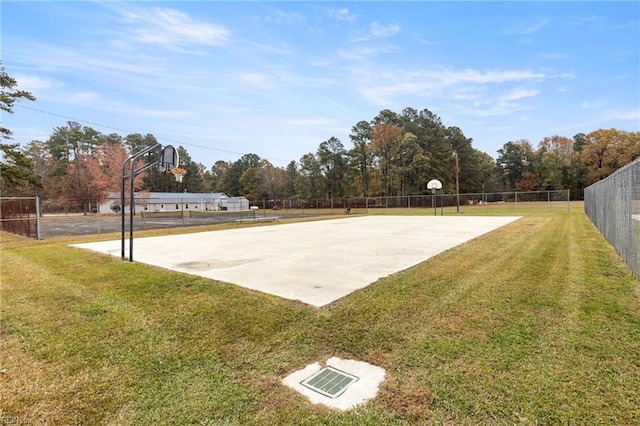 view of basketball court featuring a lawn