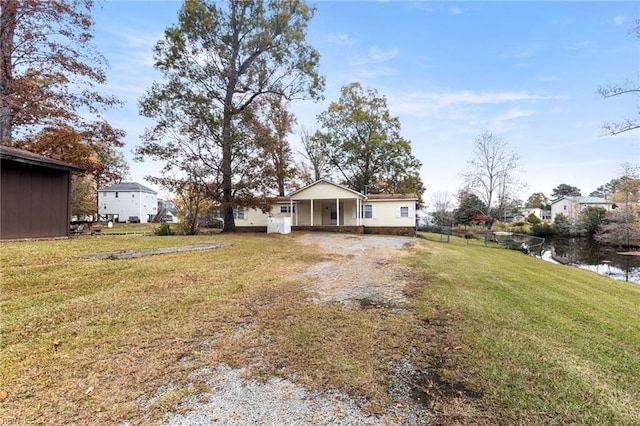 129 Arapahoe Trl, Hertford, NC 27944 - view of green lawn with driveway and a carport