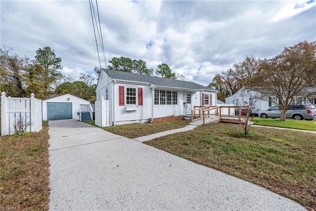 view of front of property featuring a garage, a deck, an outdoor structure, and a front lawn