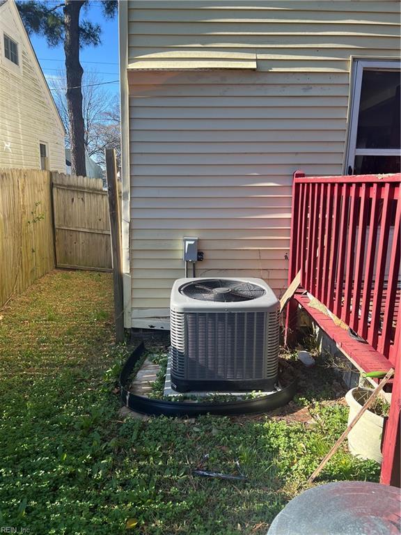 details featuring fence and central AC unit