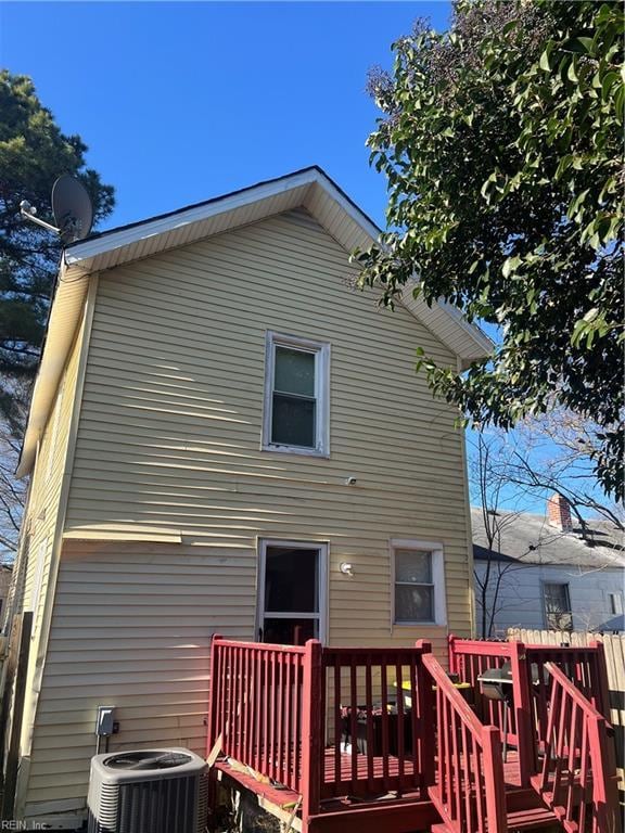 back of house with a deck and central AC