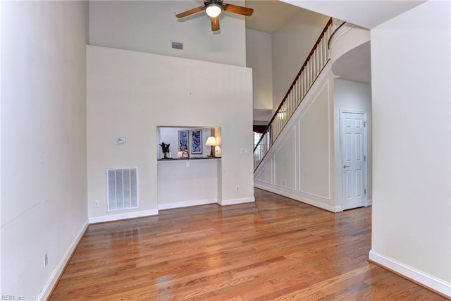 unfurnished living room featuring light wood-type flooring and ceiling fan