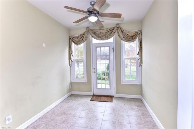 doorway to outside featuring light tile patterned floors and ceiling fan