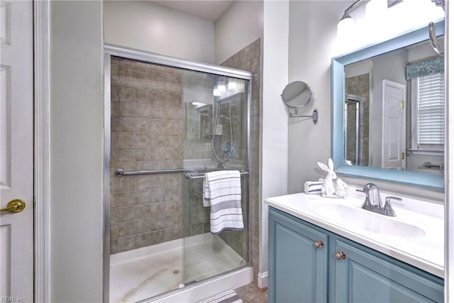 bathroom featuring tile patterned floors, vanity, and a shower with shower door