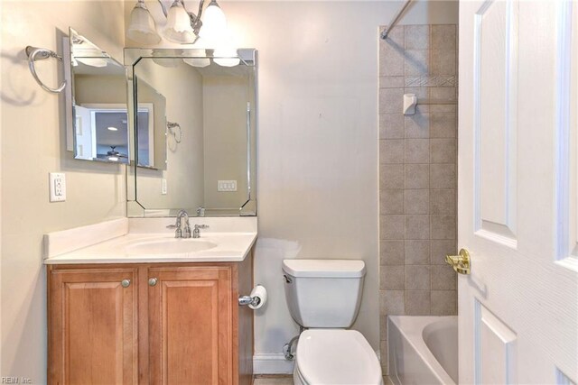 full bathroom featuring vanity, toilet, and tiled shower / bath