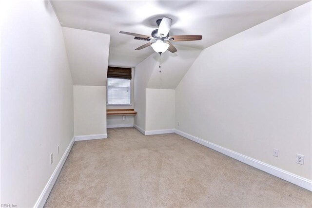 bonus room featuring light carpet and vaulted ceiling