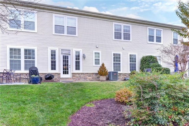 back of property featuring a yard and central AC unit