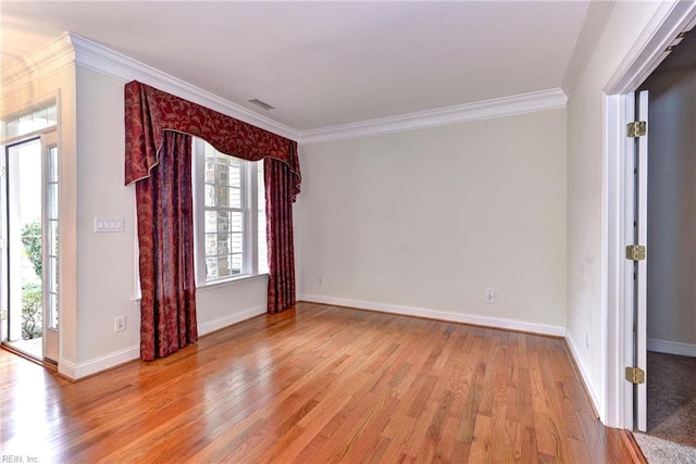 unfurnished room with light wood-type flooring and ornamental molding