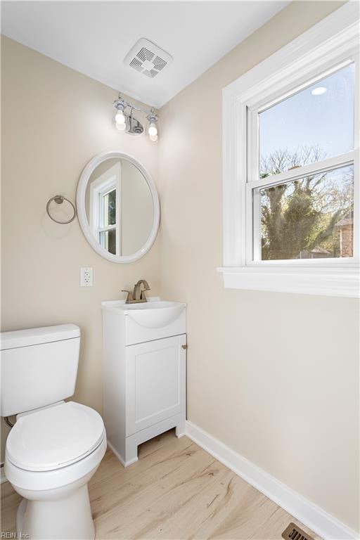 bathroom featuring hardwood / wood-style floors, vanity, and toilet