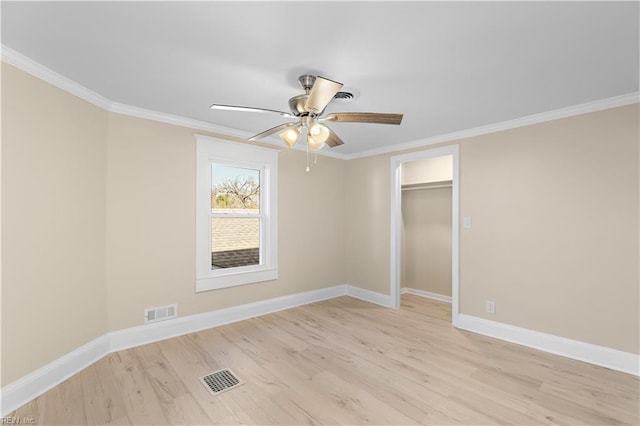 unfurnished bedroom with a closet, ceiling fan, crown molding, and light hardwood / wood-style floors