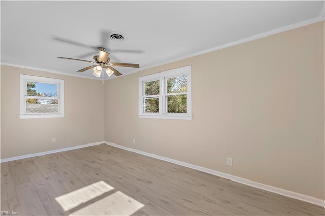 empty room featuring light hardwood / wood-style flooring, plenty of natural light, ornamental molding, and ceiling fan