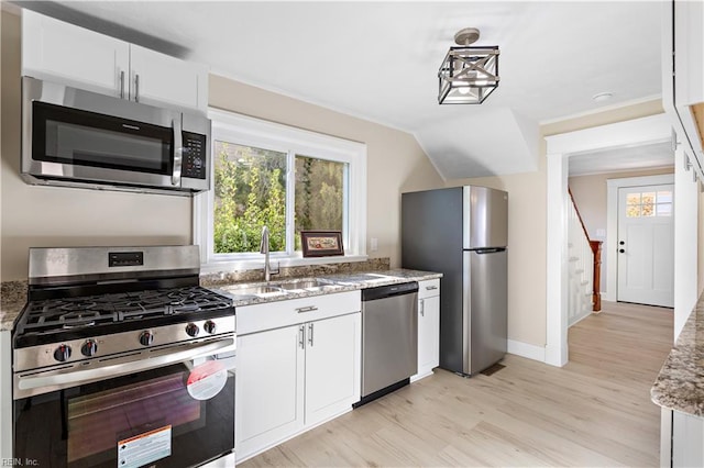 kitchen featuring light stone countertops, sink, light hardwood / wood-style floors, white cabinets, and appliances with stainless steel finishes