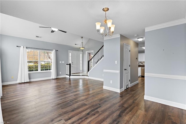 unfurnished living room with ornamental molding, ceiling fan with notable chandelier, and dark wood-type flooring