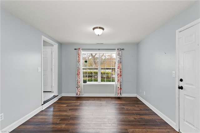 empty room featuring dark hardwood / wood-style flooring