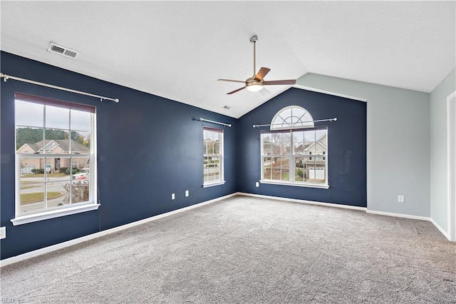 carpeted spare room with ceiling fan and lofted ceiling