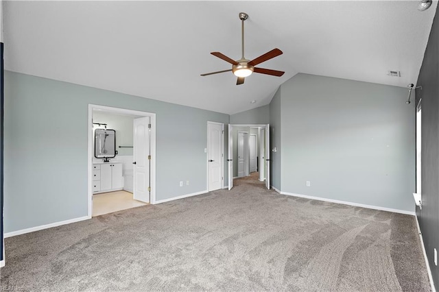 unfurnished bedroom with light carpet, ensuite bath, ceiling fan, and lofted ceiling