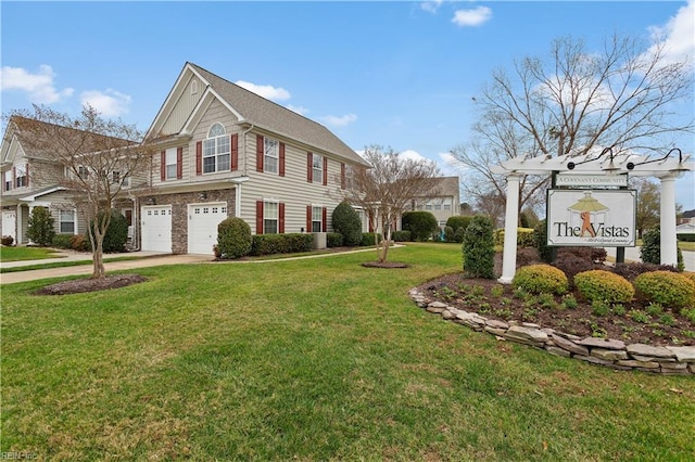 view of front of house featuring a front yard and a garage