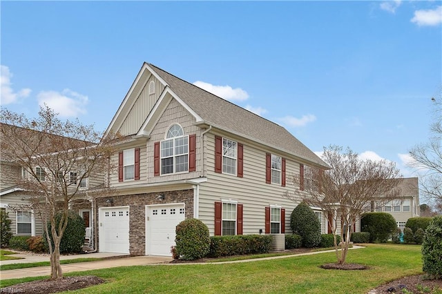 colonial inspired home with a front lawn and a garage