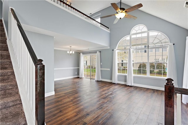 unfurnished living room featuring high vaulted ceiling, dark hardwood / wood-style floors, and a wealth of natural light