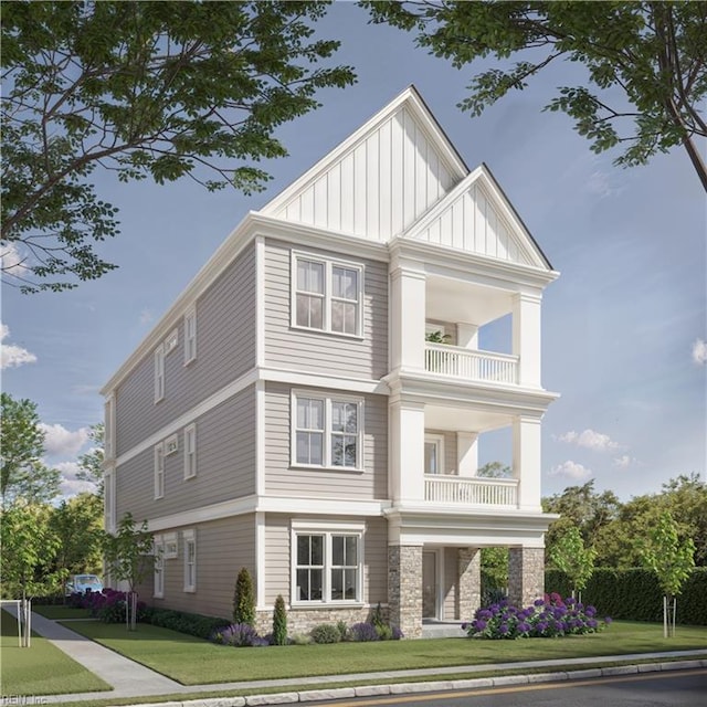 view of front of home with a balcony and a front yard