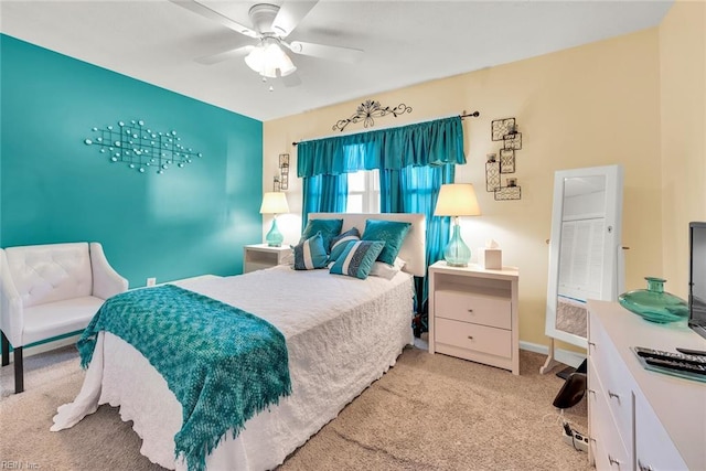 bedroom featuring light colored carpet and ceiling fan