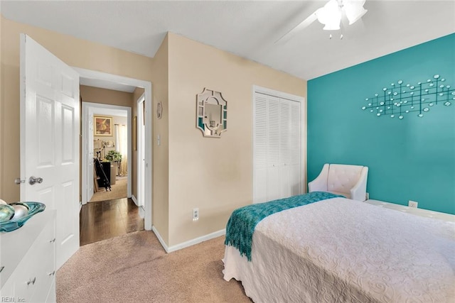 carpeted bedroom featuring a closet and ceiling fan