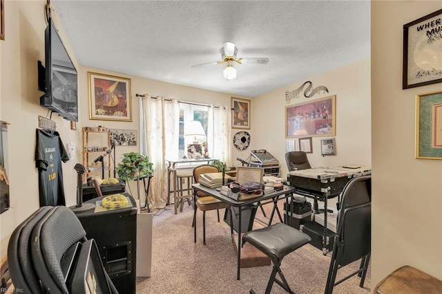 carpeted home office featuring ceiling fan and a textured ceiling