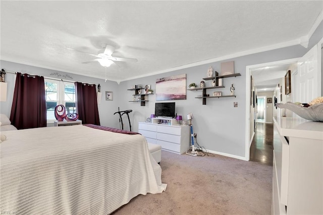 carpeted bedroom with ceiling fan and crown molding