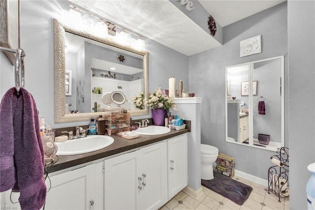 bathroom with tile patterned floors, vanity, and toilet