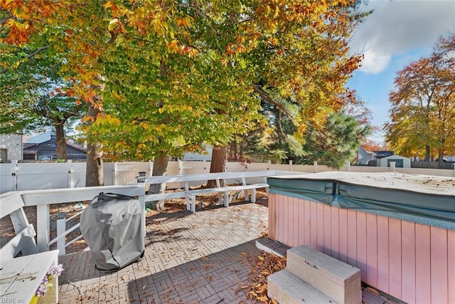 view of patio featuring area for grilling and a hot tub