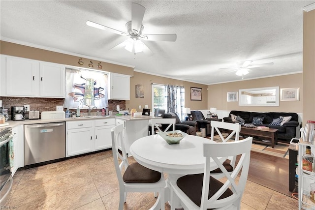 kitchen with white cabinets, crown molding, decorative backsplash, a textured ceiling, and appliances with stainless steel finishes