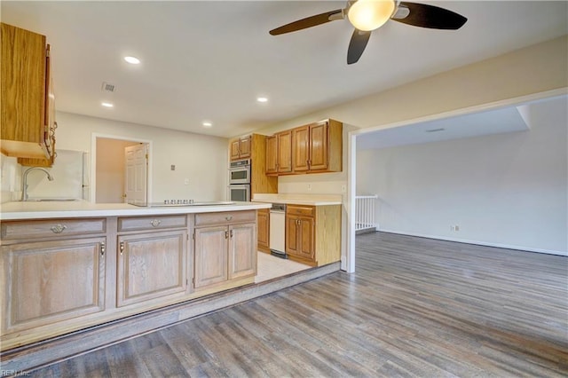 kitchen featuring stainless steel double oven, sink, ceiling fan, and wood-type flooring