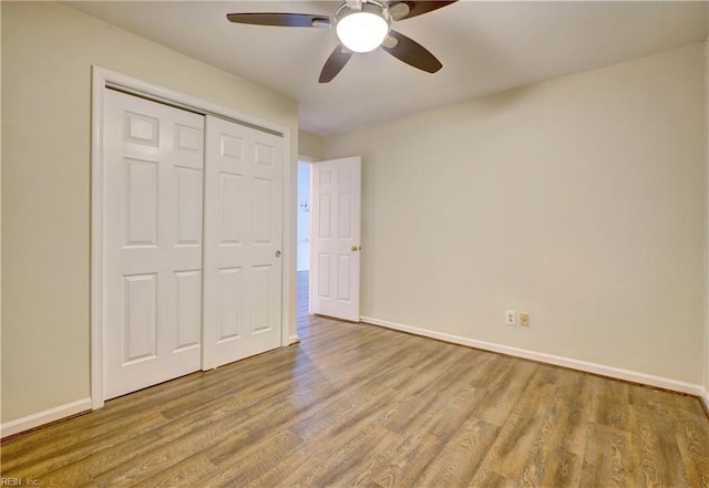 unfurnished bedroom featuring light wood-type flooring, a closet, and ceiling fan